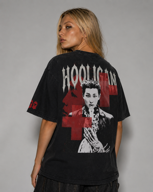 Person wearing a black t-shirt with graphic design and text on a gray background