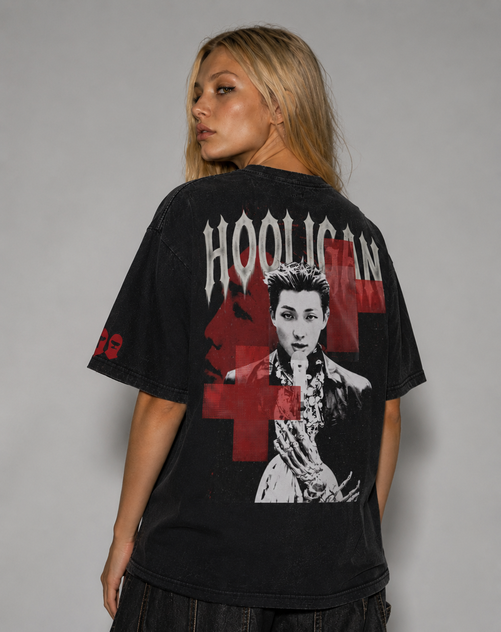 Person wearing a black t-shirt with graphic design and text on a gray background